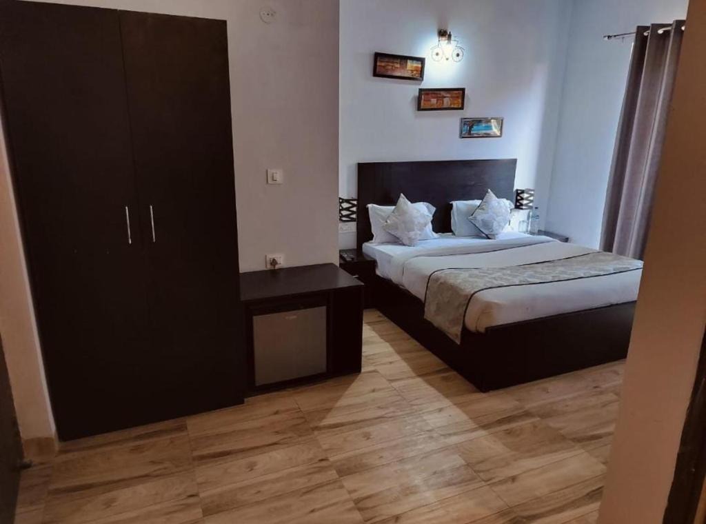 a hotel room with a bed and a night stand at Amber suits and Hotal in Vrindāvan