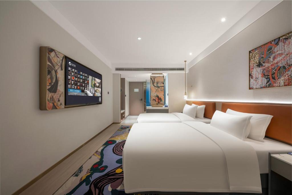 Postel nebo postele na pokoji v ubytování Insail Hotels Guangzhou Beijing Road Pedestrian Branch