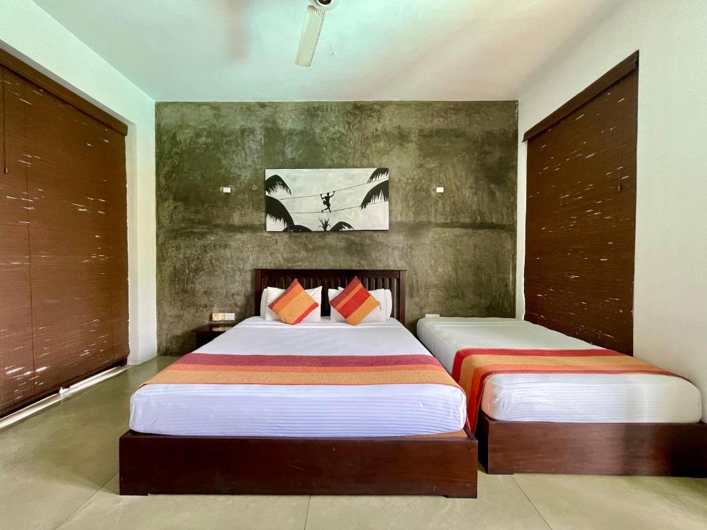 Postel nebo postele na pokoji v ubytování Olanro Hotel Negombo