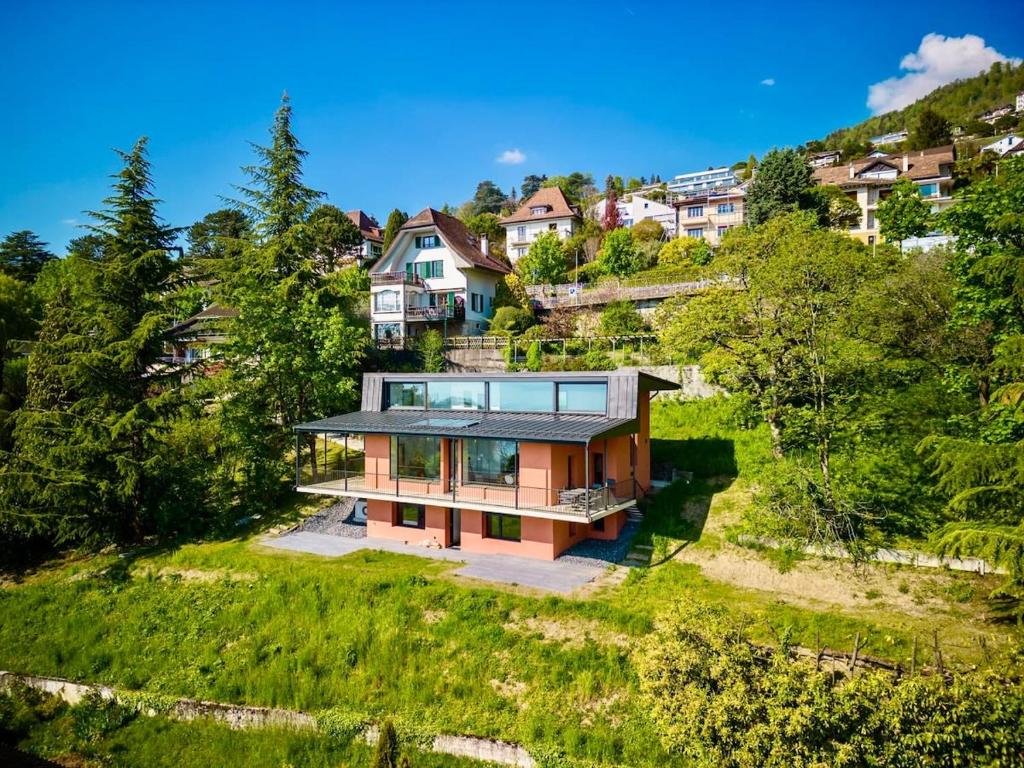 an aerial view of a house on a hill at Villa Rose in the center of Montreux by GuestLee in Montreux