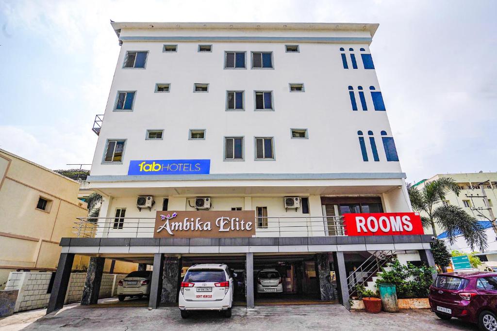 a white car parked in front of a building at FabHotel Ambika Elite in Vijayawāda