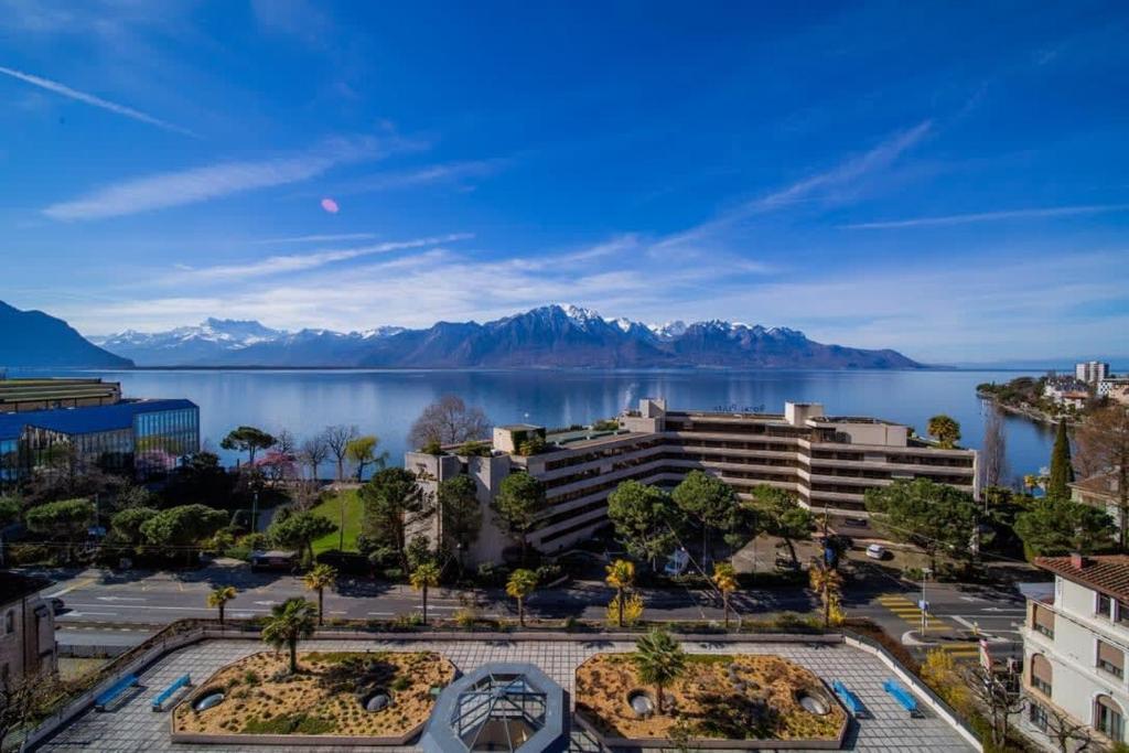 a view of a city and a body of water at Alpine Stunning Apartment in Montreux by GuestLee in Montreux