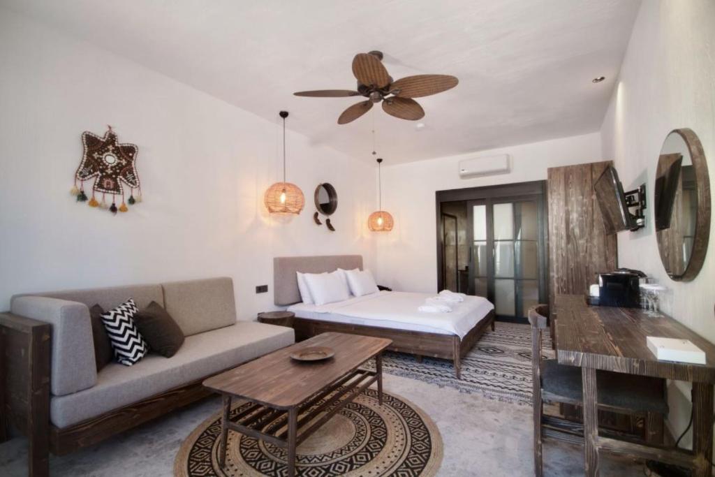 a living room with a couch and a bed at Beach 222 Oludeniz in Fethiye