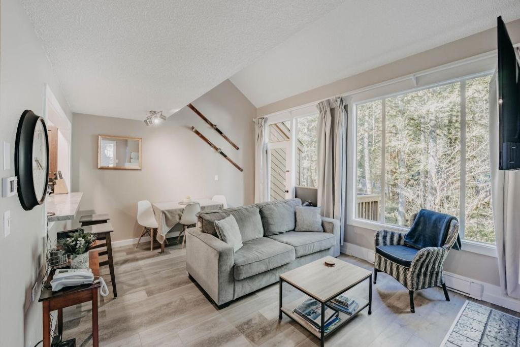 a living room with a couch and a window at 45SW-Fireplace-Dishwasher-Washer Dryer-Sleeps 4 condo in Glacier