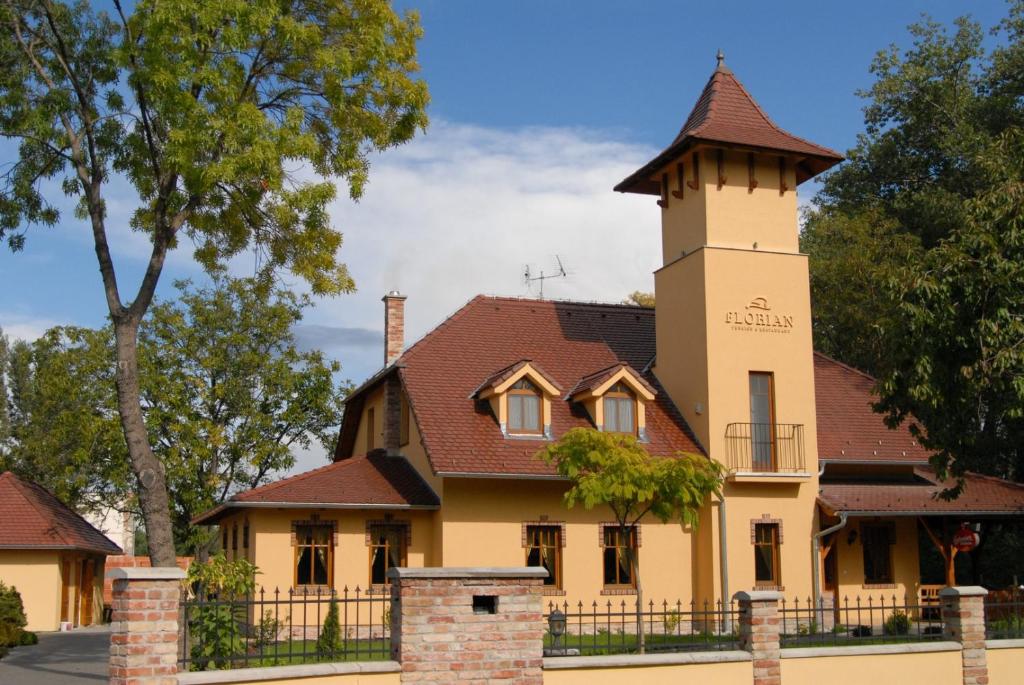 a building with a tower on top of it at St. Florian Restaurant & Pension in Vrakúň