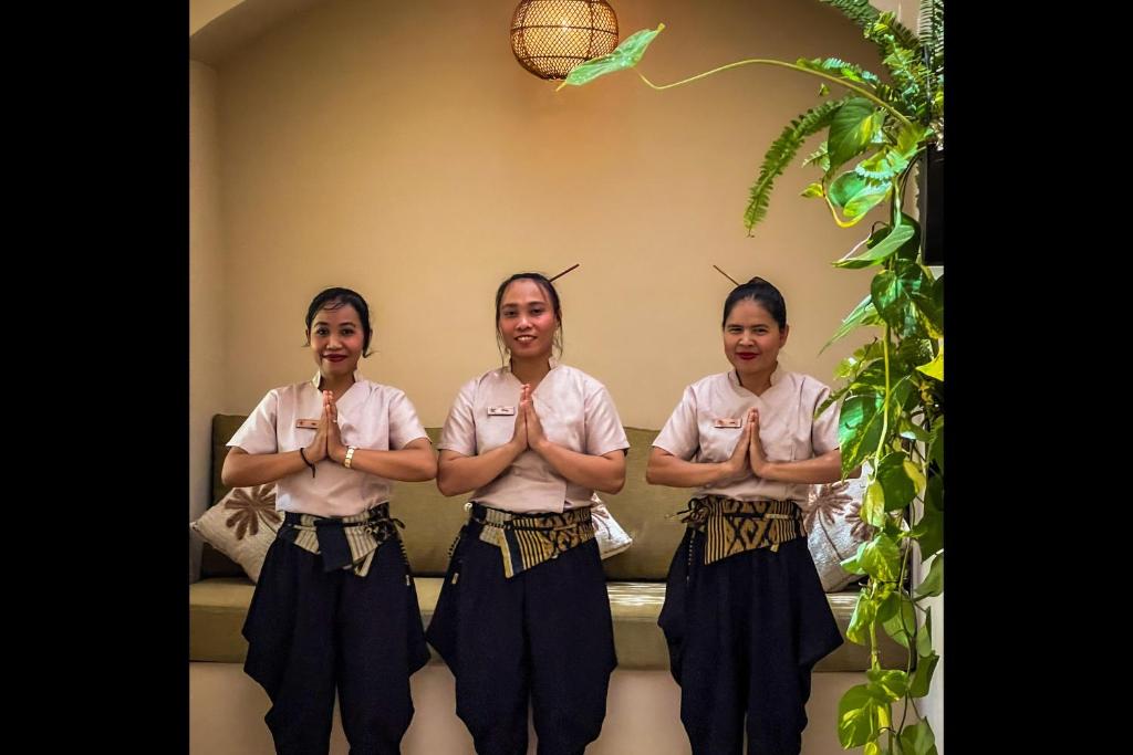 three women are performing aorative yogaorativeorativeorativeorativelicationlicationlicationlicationlication at Rascals Hotel - Adults Only in Kuta Lombok