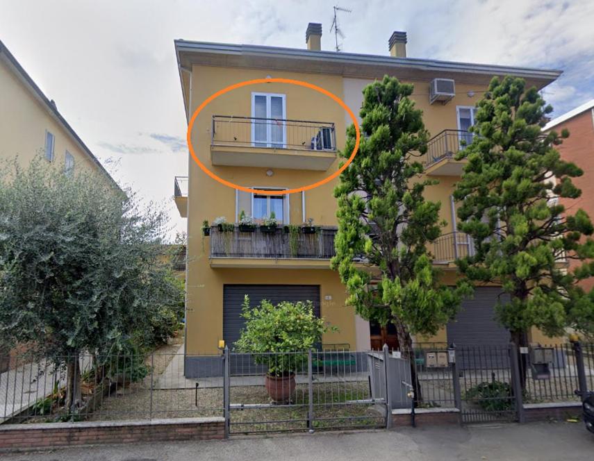 a yellow house with an orange circle on it at Deluxe Appartament near Racetrack 110 mq 4-5 People in Imola