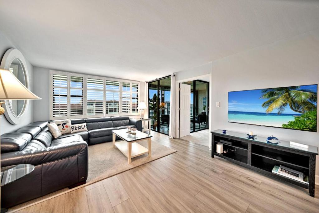 a living room with a couch and a flat screen tv at Loggerhead Cay #324 in Sanibel