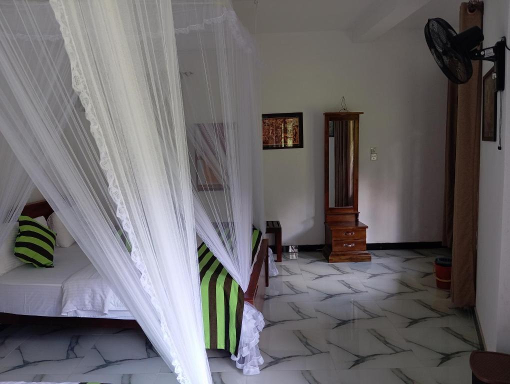 Postel nebo postele na pokoji v ubytování Forest Paddy Homestay