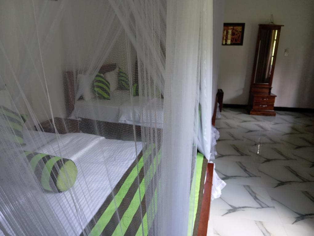 Postel nebo postele na pokoji v ubytování Forest Paddy Homestay
