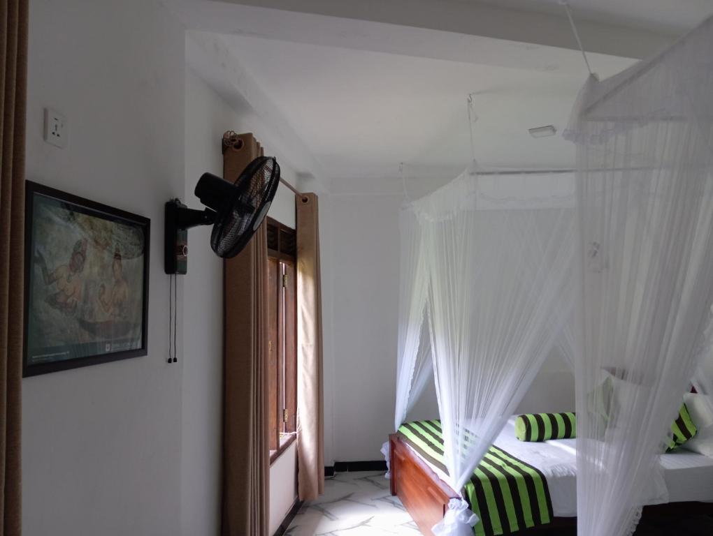Postel nebo postele na pokoji v ubytování Forest Paddy Homestay