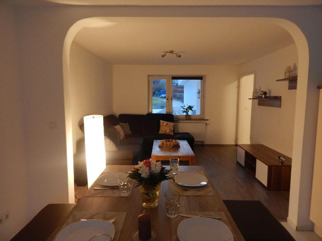 ein Wohnzimmer mit einem Tisch und einem Sofa in der Unterkunft Ferienhaus Königsberg Haus 2 in Scharbeutz