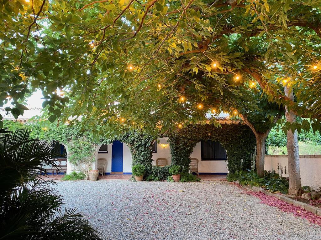 a walkway with christmas lights in a building at MASIA CENTENARIA EN SITGES in Sitges
