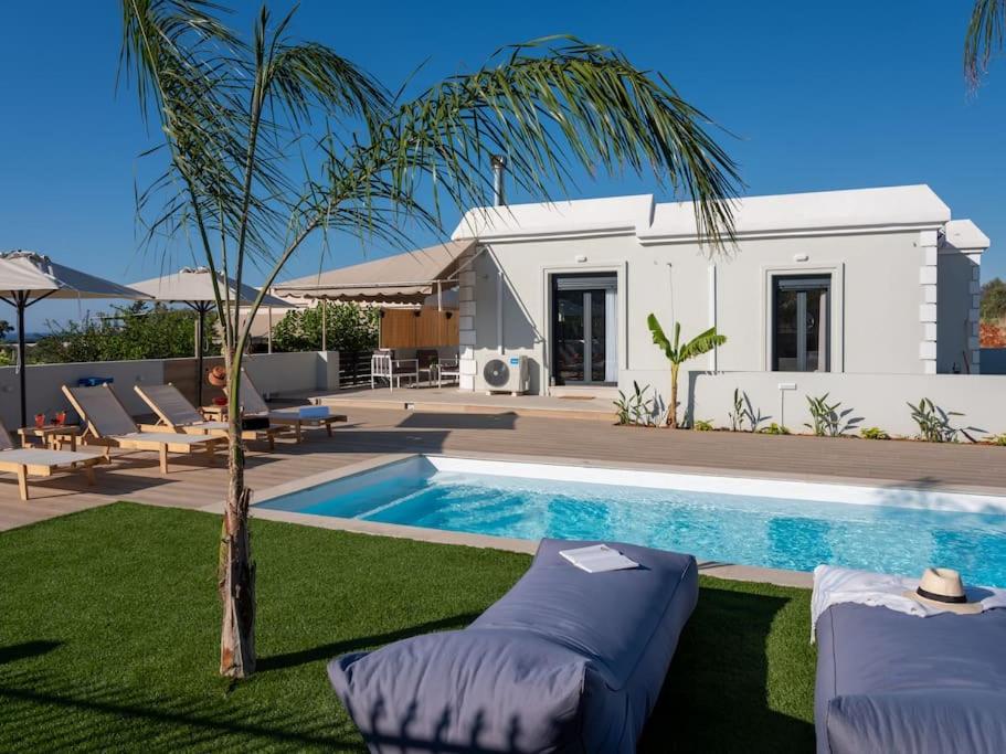 a villa with a swimming pool and a house at Villa Helia by Smaris Collection in MALIA in Kartsindanós