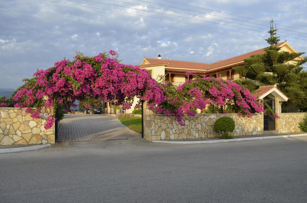 een hek met een bos roze bloemen erop bij Lefki Studios in Lakíthra