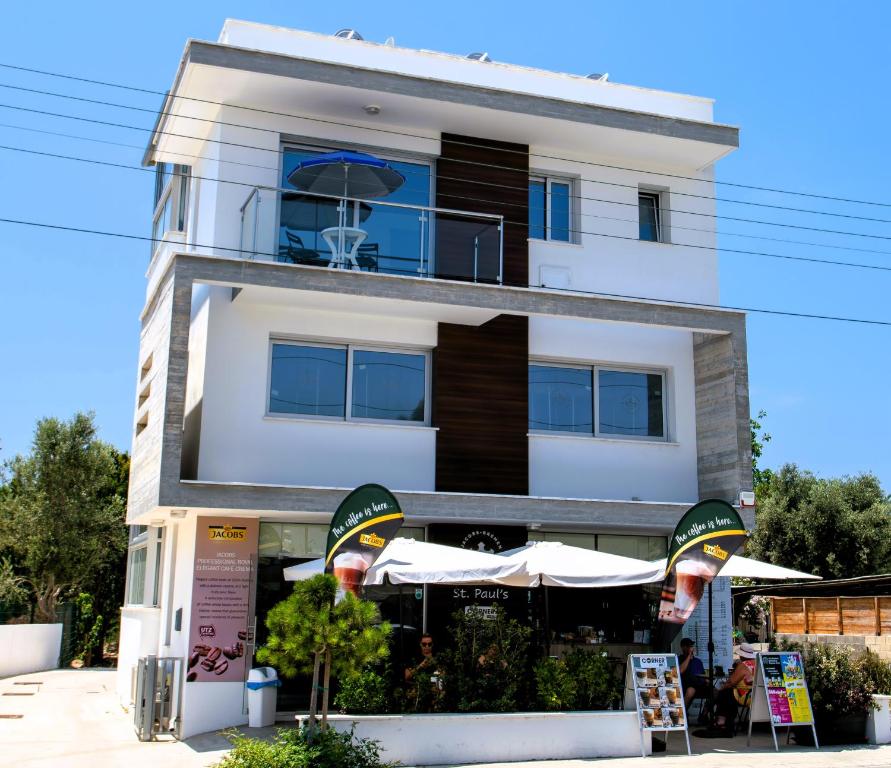 a building with a cafe in front of it at Dream- Downtown-Studios in Paphos