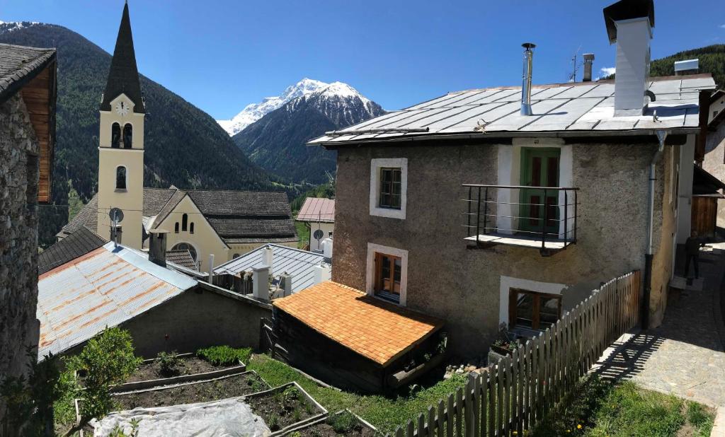 a small town with a church and a mountain at Haus 59 Stilfs in Stelvio