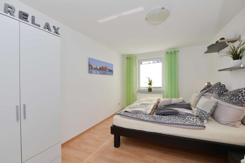 a bedroom with a bed with pillows and a window at Alte Schmiede in Franken Vorstadt