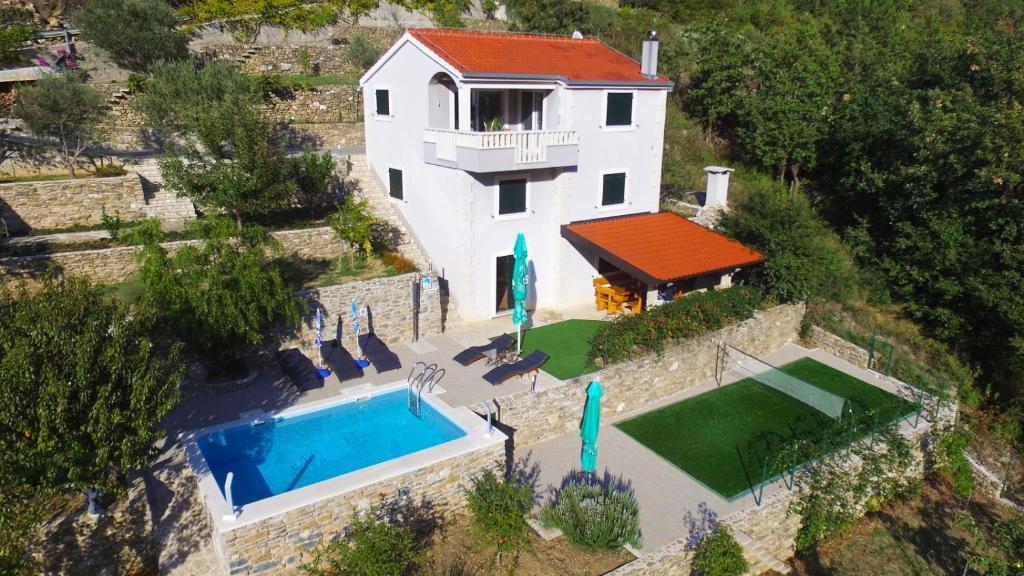 an aerial view of a house with a swimming pool at Holiday home in Omis with terrace, air conditioning, WiFi, washing machine 5202-1 in Omiš