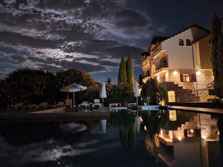 a house and a swimming pool at night at Villa Anna in Leptokarya