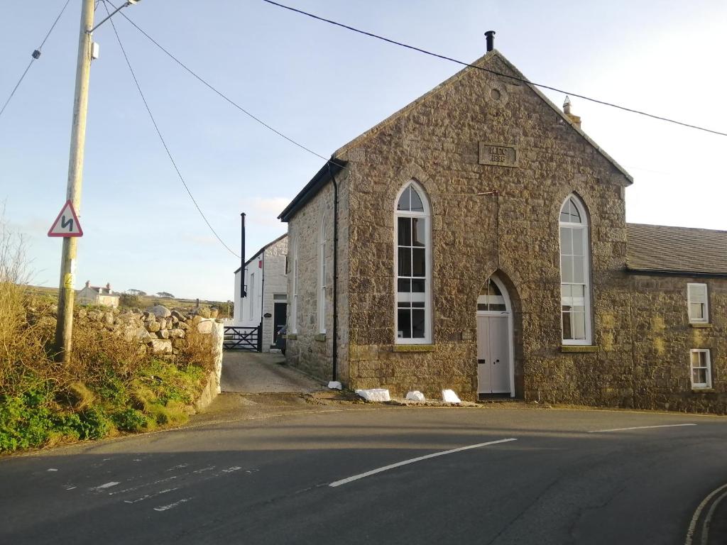 an old stone church on the side of a road at Old Chapel in St Just