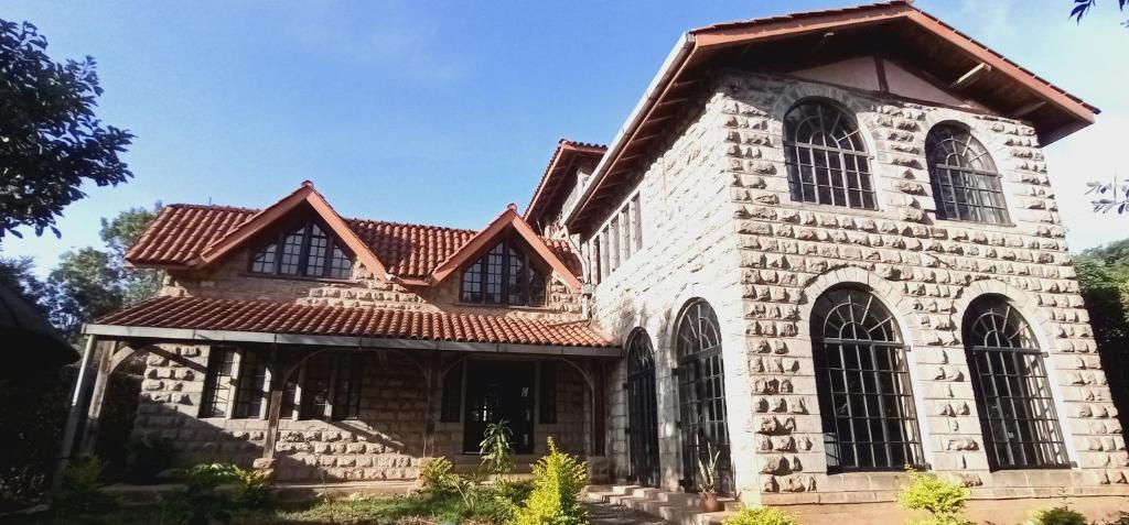 an old stone building with a red roof at Amani House in Nairobi