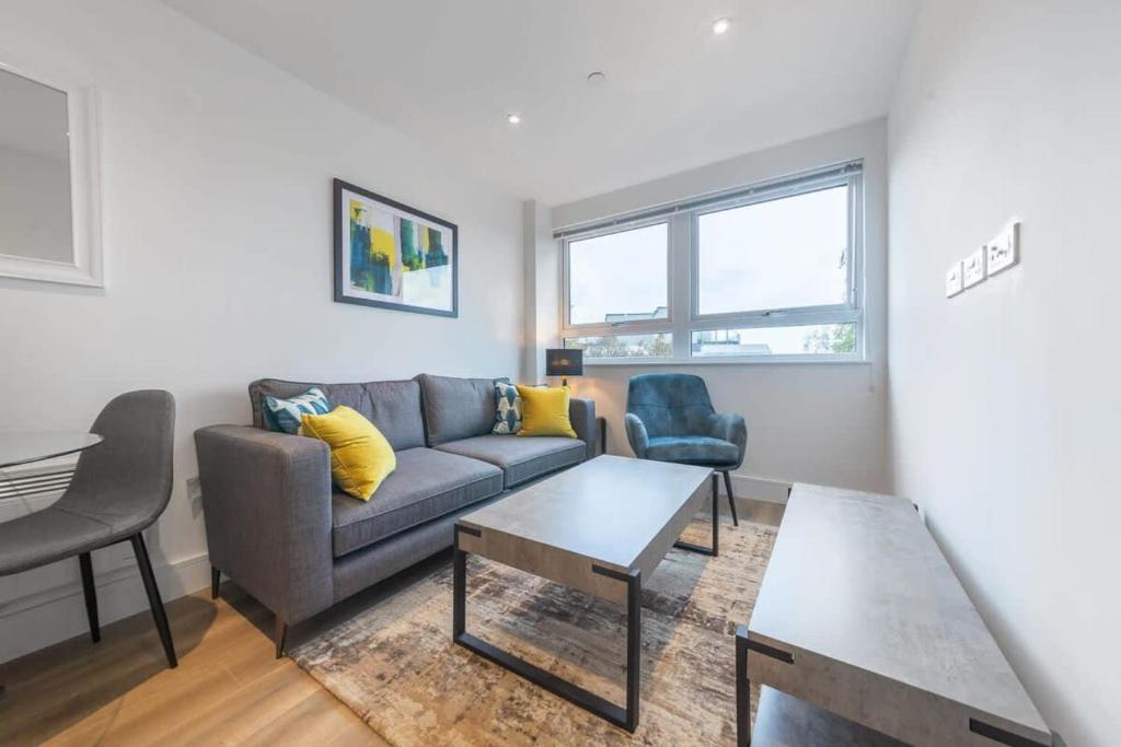 uma sala de estar com um sofá e uma mesa em Modern and Bright 1 Bed Apartment in East Grinstead em East Grinstead