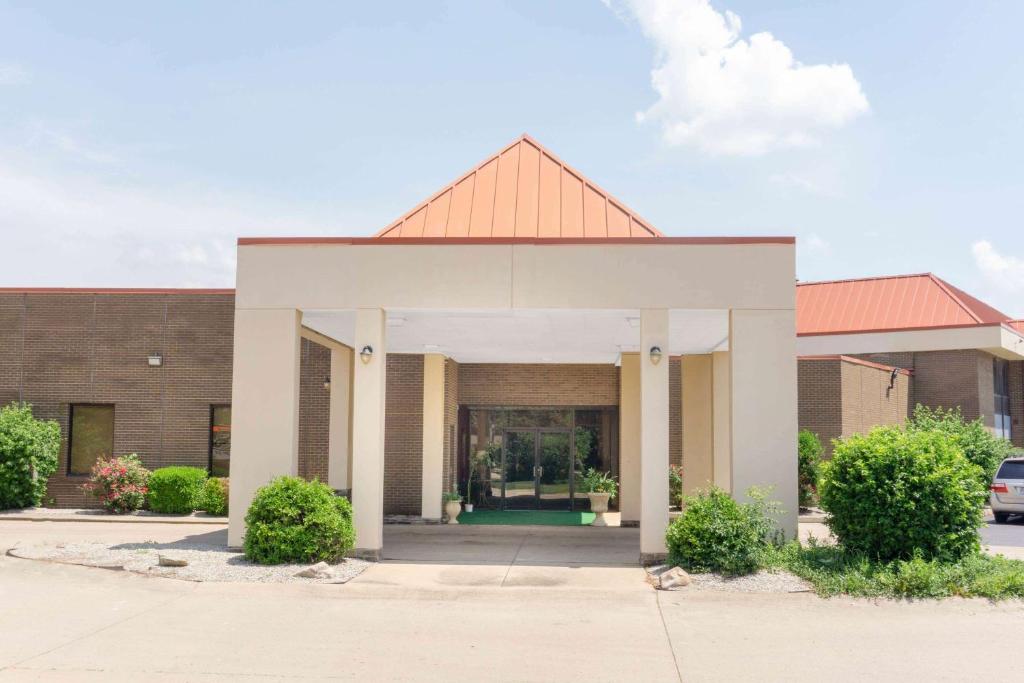 a brick building with a white and orange roof at Super 8 by Wyndham Harrison OH in Harrison