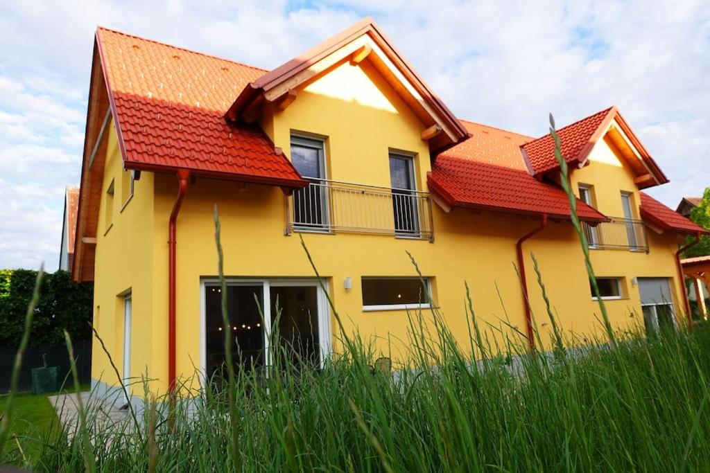 a yellow house with a red roof at Charmante Doppelhaushälfte im idyllischen Stainz in Stainz