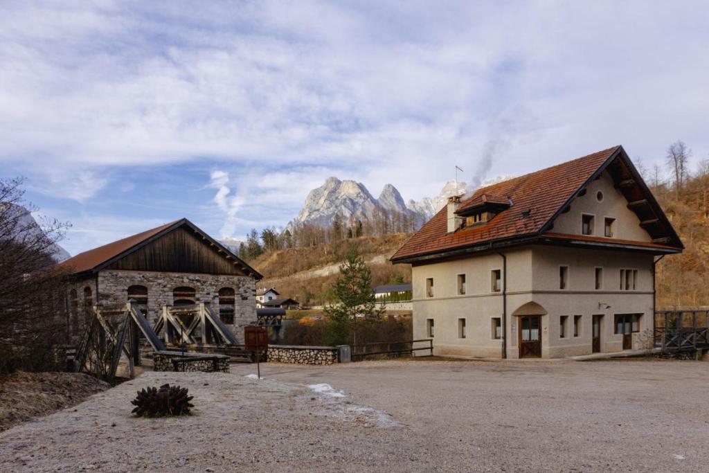 a large building with a mountain in the background at ALLE ANTICHE MINIERE - CASA VACANZE in Zenich