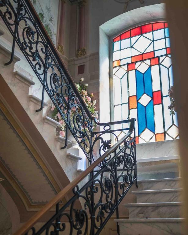 a flight of stairs with a stained glass window at Luxury Liberty House - VILLA & SPA in Alghero