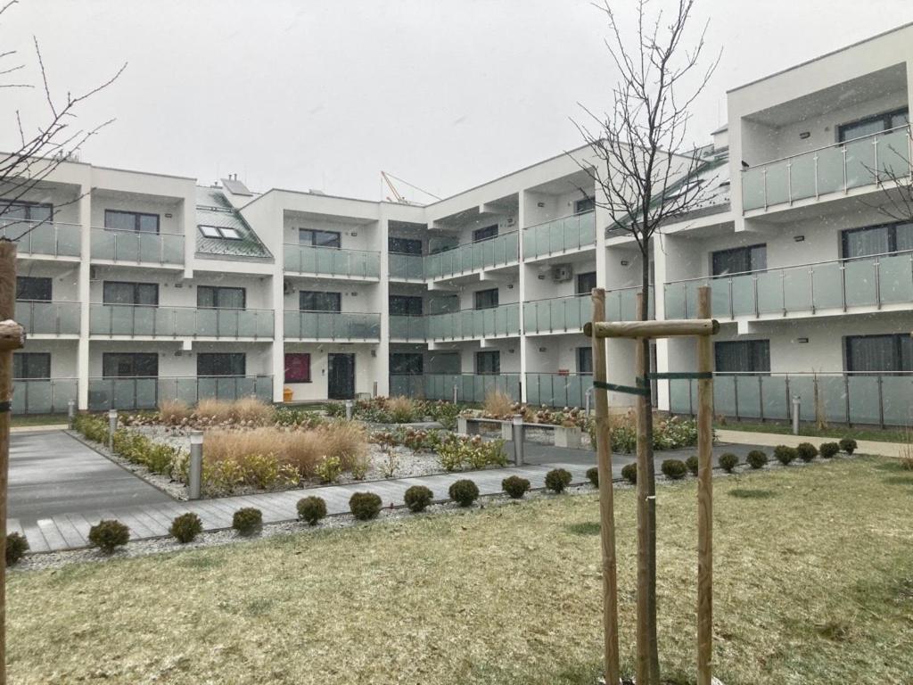 a large apartment building with a garden in front of it at Apartament Berlinek in Grzybowo
