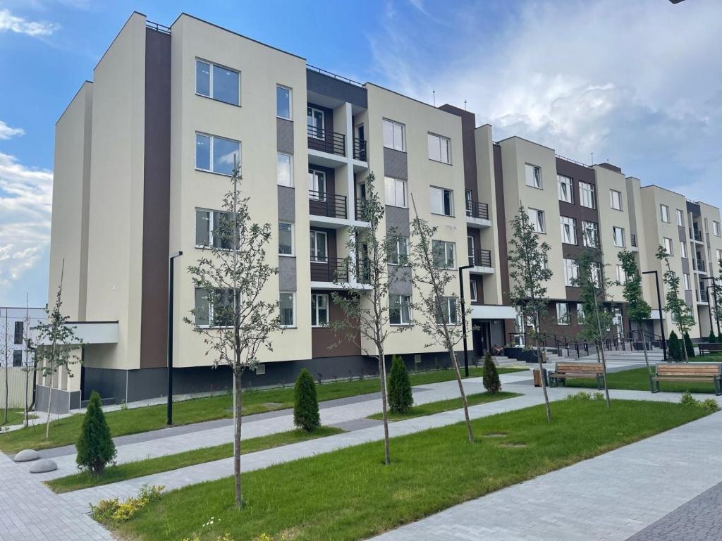 an apartment building with trees in front of it at FlatService Smart House in Kyiv