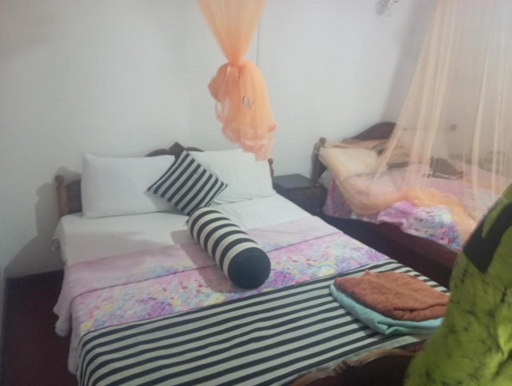 Postel nebo postele na pokoji v ubytování Forest Paddy Homestay