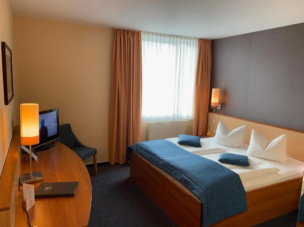 Postel nebo postele na pokoji v ubytování Atrium Hotel Krüger