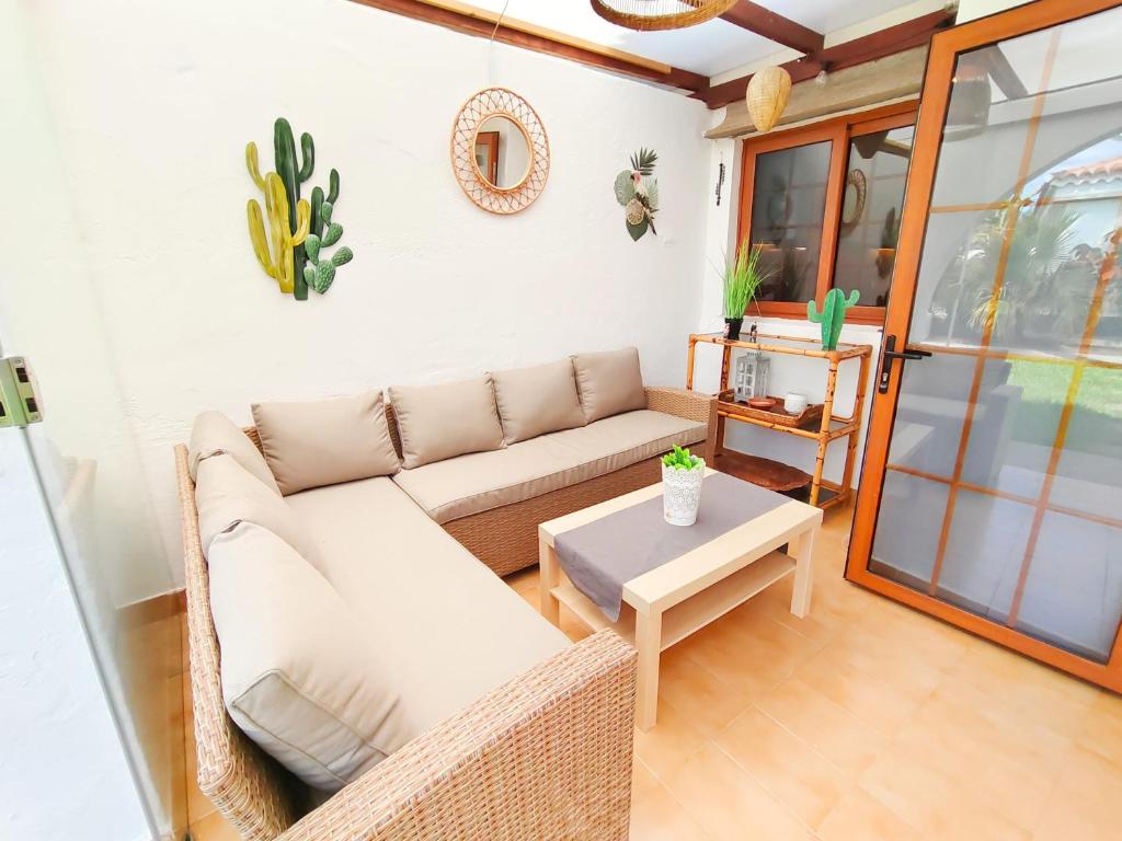 a living room with a couch and a table at Parque Golf 9 in Maspalomas