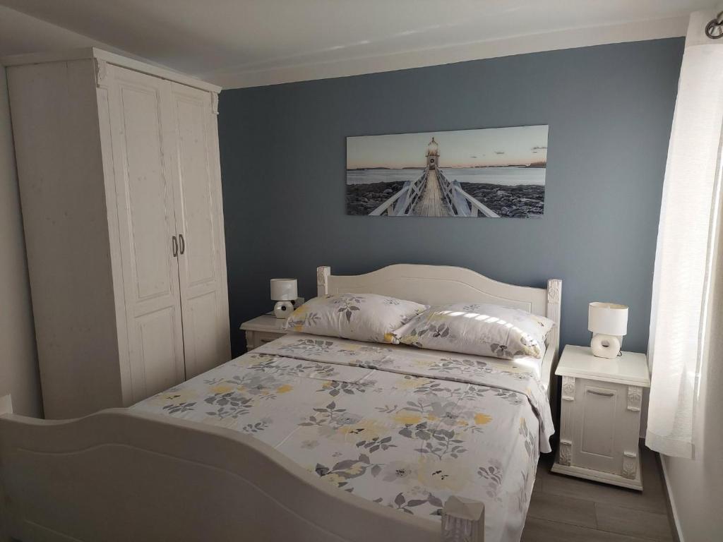 a bedroom with a bed and a picture on the wall at Studio Nikola in Baška