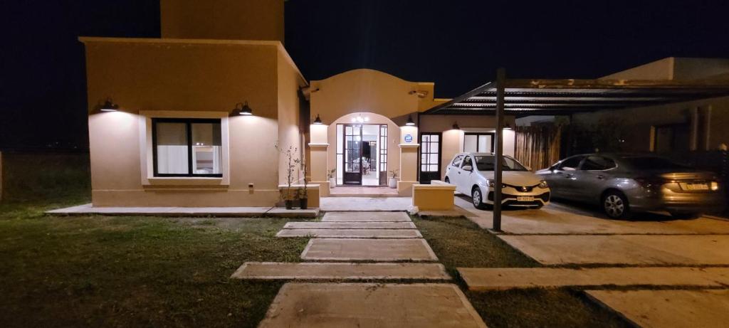 una casa con dos coches estacionados en un estacionamiento por la noche en san lorenzo chico salta en San Lorenzo