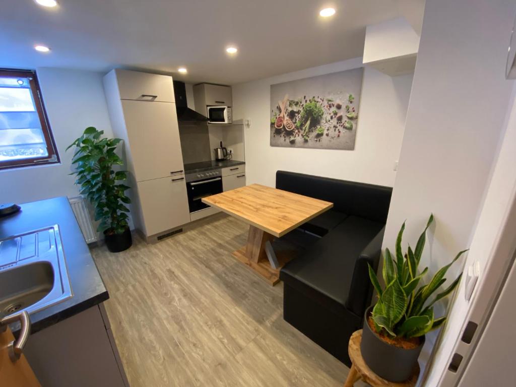 a kitchen and living room with a table and a couch at Haus Christina in Döllach