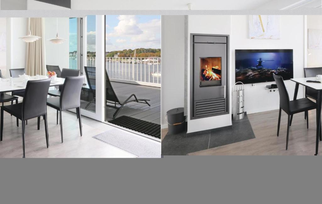 a dining room with a fireplace and a table with chairs at Priwallpromenade 23, Whg 11 in Travemünde