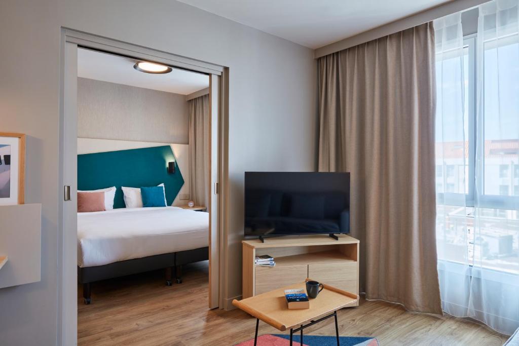 Postel nebo postele na pokoji v ubytování Aparthotel Adagio Heidelberg
