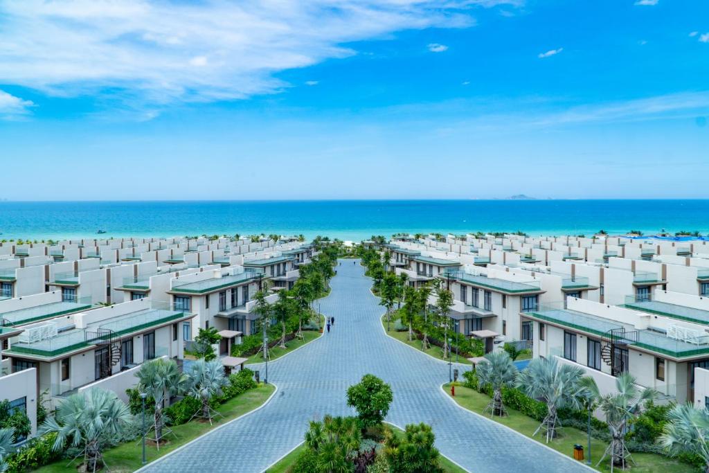 an aerial view of an apartment complex near the beach at Mysterio Pool Villas - Wyndham Garden Resort in Cam Ranh