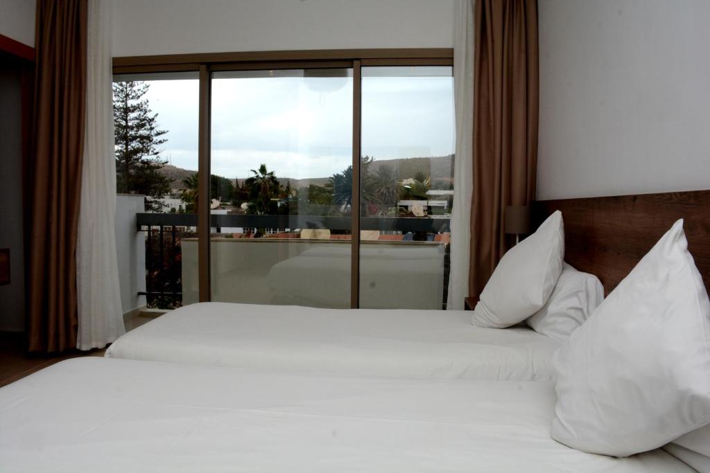 Postel nebo postele na pokoji v ubytování Hotel Aferni