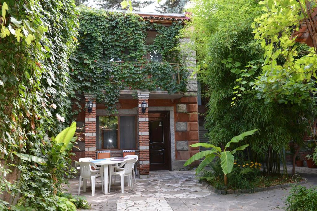 a patio with a table and chairs in front of a building at Tourist in Akhaltsikhe