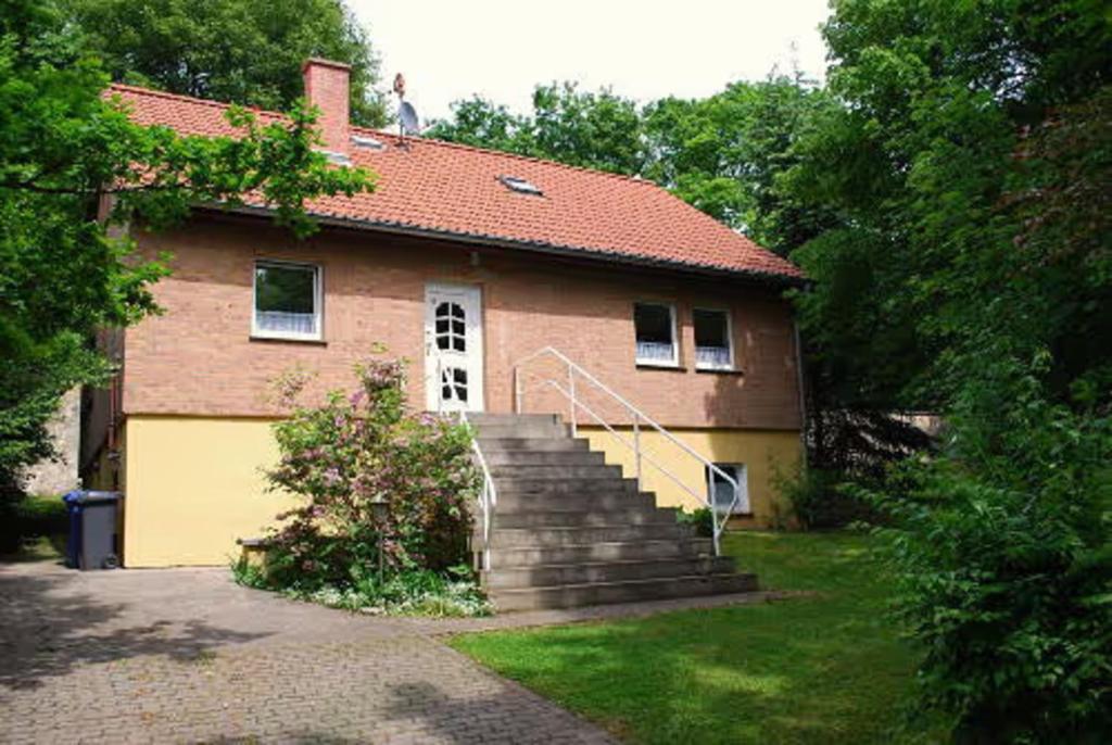 a brick house with a staircase in front of it at Ferienhaus Teufelsmauer in Cattenstedt