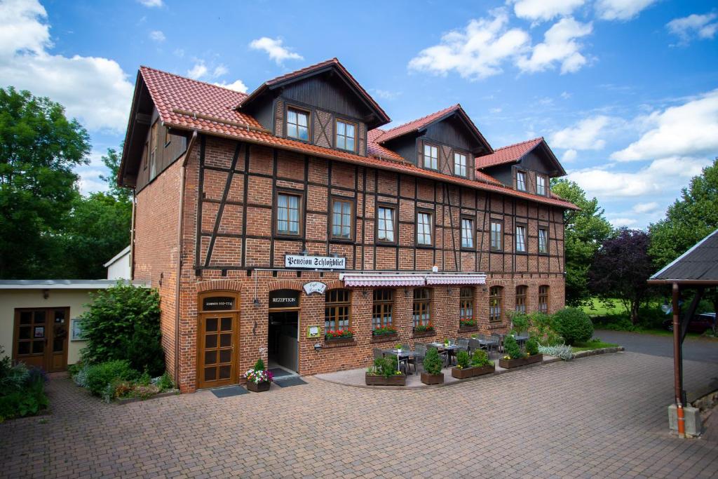 a large brick building with a courtyard in front of it at Schlossgartenpassage in Ohrdruf