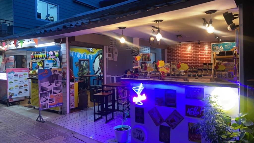 a bar with a neon sign in front of it at Double B House in Phi Phi Don