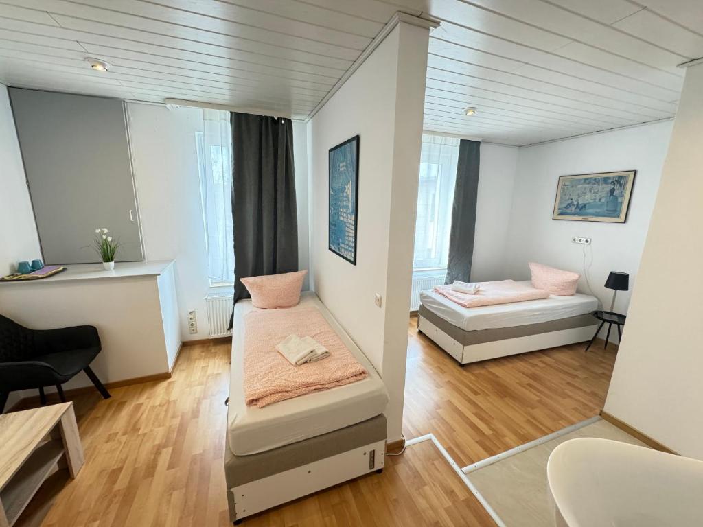 mały pokój z dwoma łóżkami i kanapą w obiekcie Pension Sonnenschein w mieście Halle (Saale)