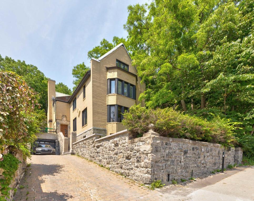 a large house with a stone wall at M11 Heritage Mansion 1BR unit in heart of MTL in Montreal