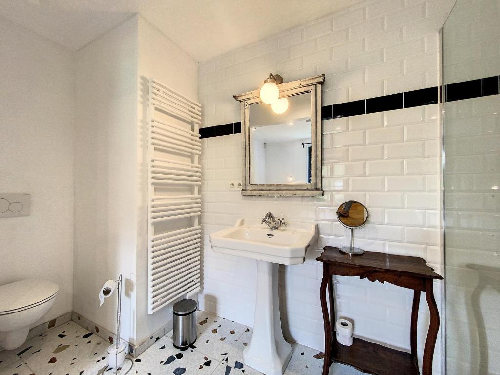 a white bathroom with a sink and a mirror at Gîte à Esneux - A La Belle Epoque d&#39;Esneux in Esneux
